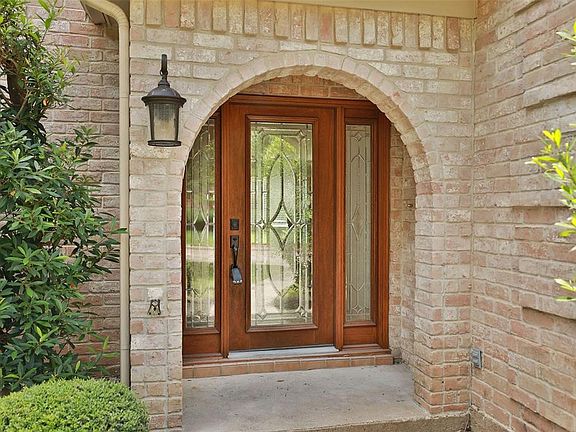 An upclose view of the covered front entry with gorgeous front door!