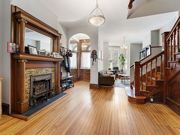 Decorative fireplace and high ceilings complete the space