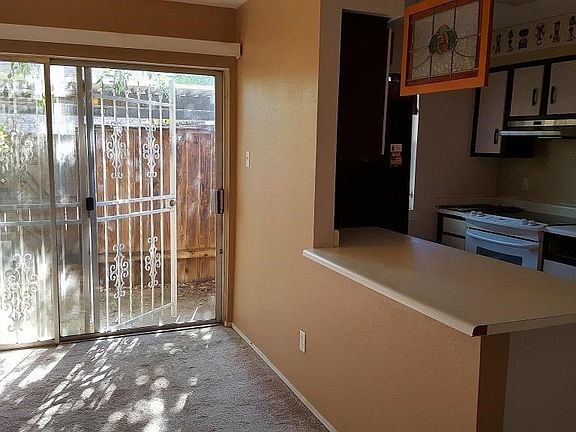 Dining area & kitchen have entry from patio & carport via sliding doors.