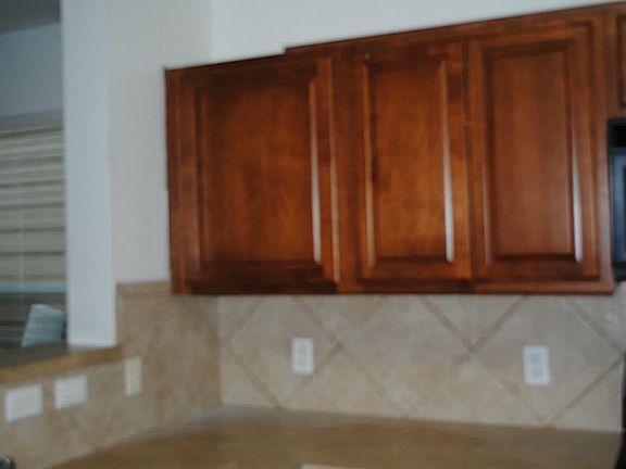Upgraded kitchen cabinets and backsplash.
