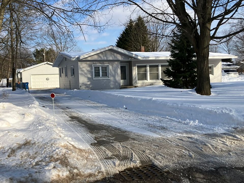 View of the front of the house from the mouth of the concrete driveway.