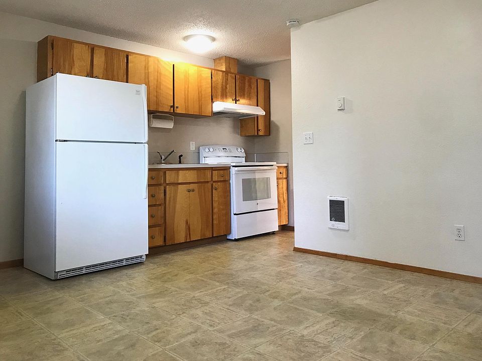 Kitchen opens to living room. Pantry is across from range.