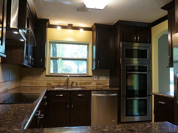 Custom Built 42" Ashwood cabinets
 and Travertine backsplash