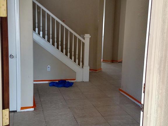 Entryway, closet under stairs and another closet opposite end of staircase.