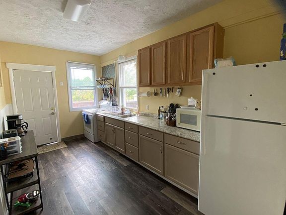 Full kitchen with appliances, coffee bar, cook, and dishware for meal prep.