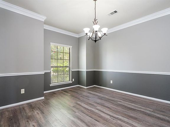 Just off the entry, a spacious formal dining room awaits you! Crown molding, chair molding and custom paint makes this a very inviting space to sit and have a meal with family or friends, or maybe host a card night!