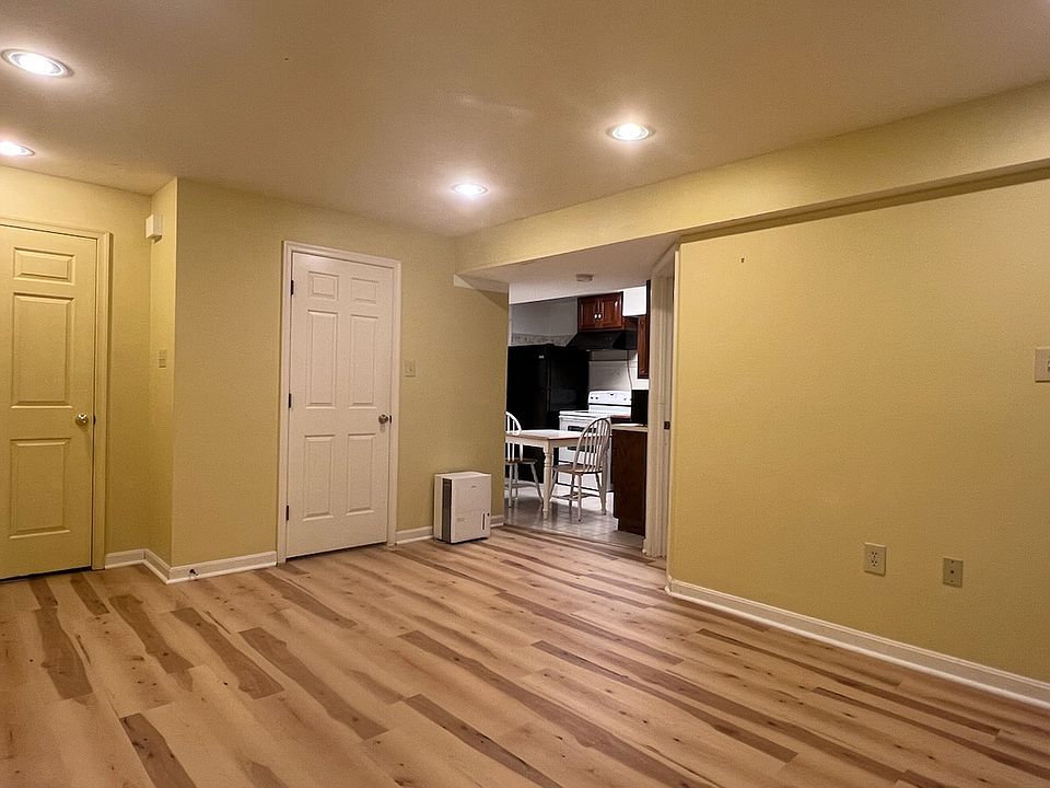 Living room w/ two closets, connected to kitchen