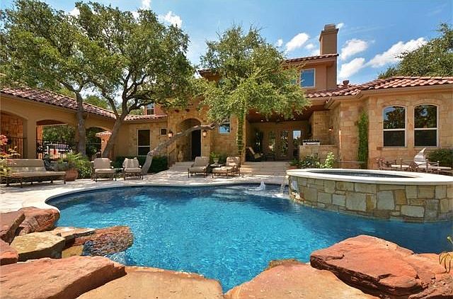 Gorgeous private front courtyard with sparkling pool and lush low-maintenance landscape.  During dry seasons, this property still continues to look like a resort style oasis.  #droughttolerant