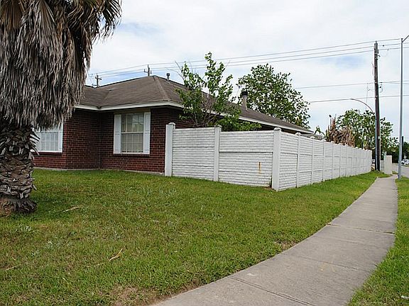 Brick fence on one side and back of house.