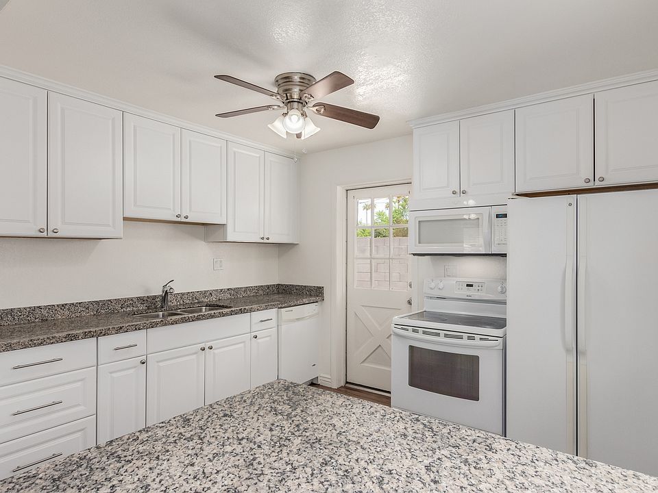 Kitchen, including electric stove, over the range microwave and side by side refrigerator