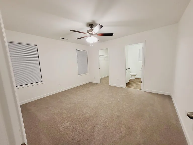 Master bedroom with walk in closet and full bathroom