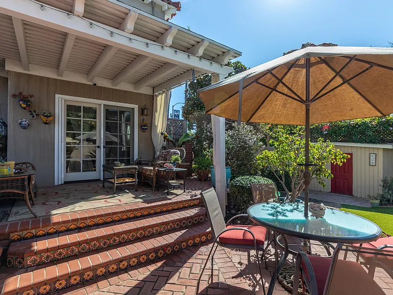 Outdoor dining tables with additional seating on porch