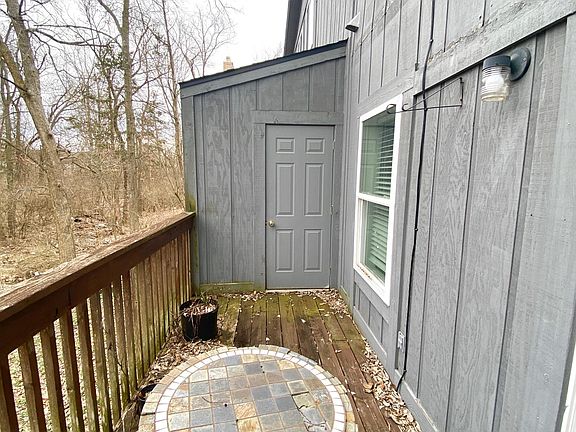 Patio off of living room with storage area.