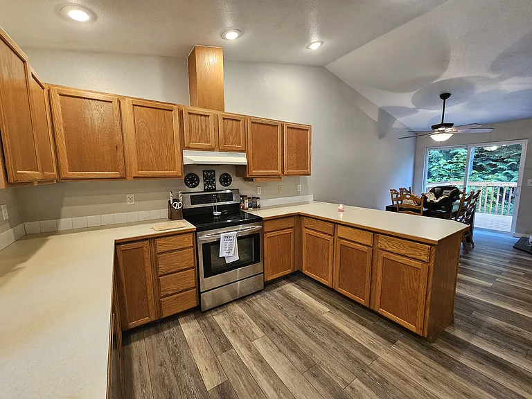 Vaulted ceilings. Kitchen overlooks dining and living space.