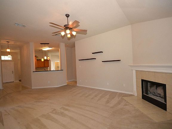 A tile-surround corner fireplace is the focal point in the r