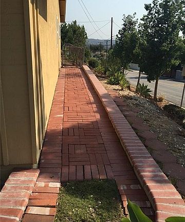 West side of home has a brick walkway.