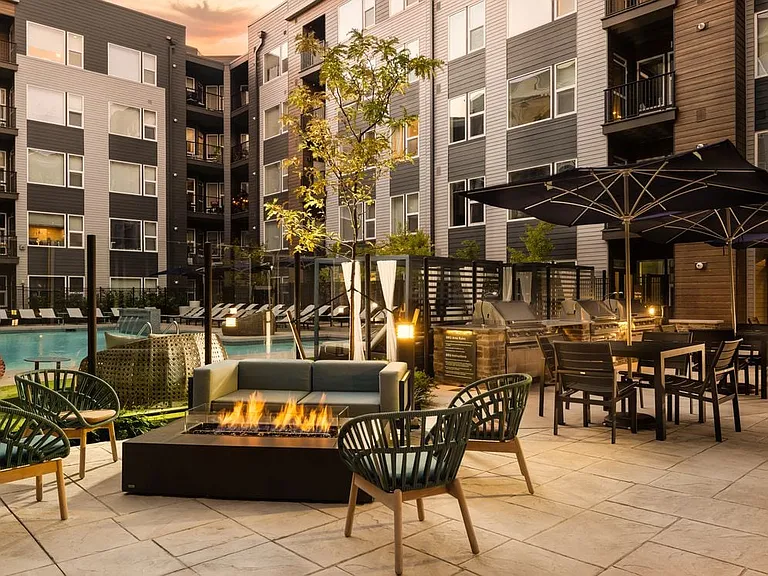 Courtyard with outdoor fireplace, pool, and lounging area