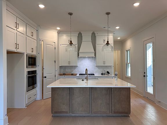 Beautiful Kitchen with Quartz, SS appliances, oversized island and Cabinets to the Ceiling.