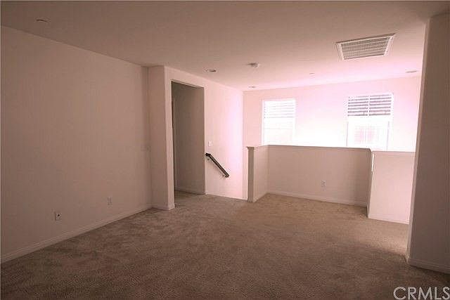 This photo shows the loft, a spacious area perfect for another living room or study space.