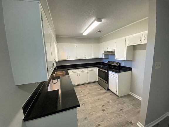 Spacious updated kitchen with new stainless steel appliances.