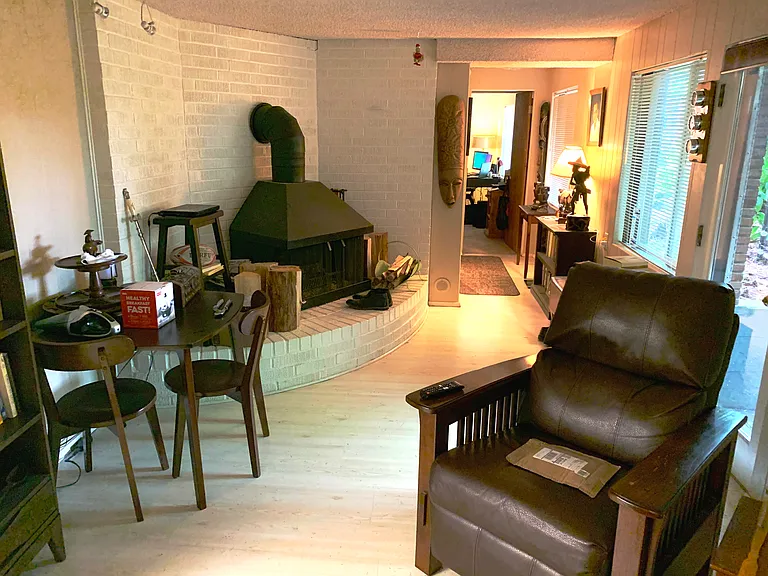 Living Room/Hallway. Photos show the unit furnished by previous tenants; the unit will be delivered vacant.
