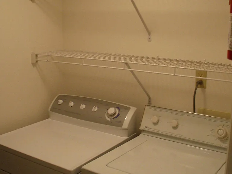 Super convenient central utility room with washer and dryer and lots of shelf space