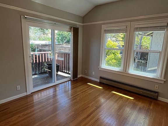 Bedroom 1 with new patio door to balcony and backyard