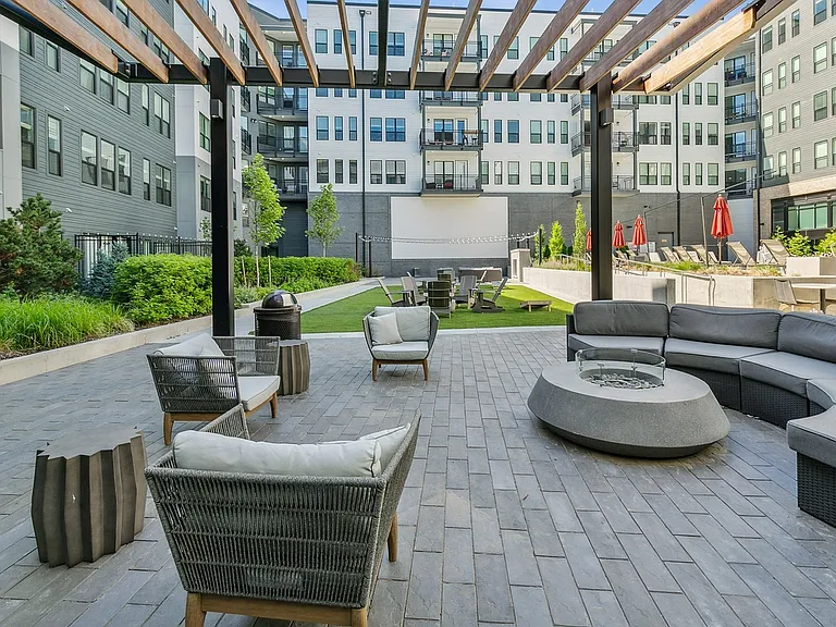 Unwind under the pergola in this stylish outdoor lounge_perfect for movie nights and laid-back gatherings.