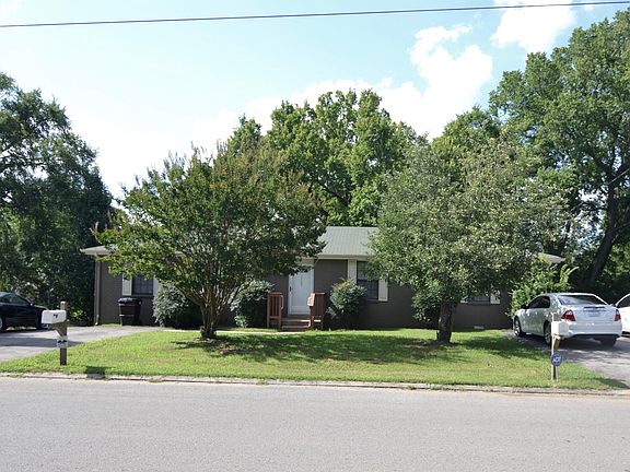 asphalt driveway and mature landscaping