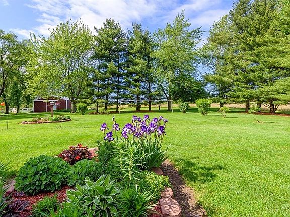LANDSCAPED GARDENS & MATURE TREES OFFER A PRIVATE PARK LIKE SETTING!