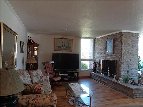 A Stone wood burning fireplace is in the Living Room.