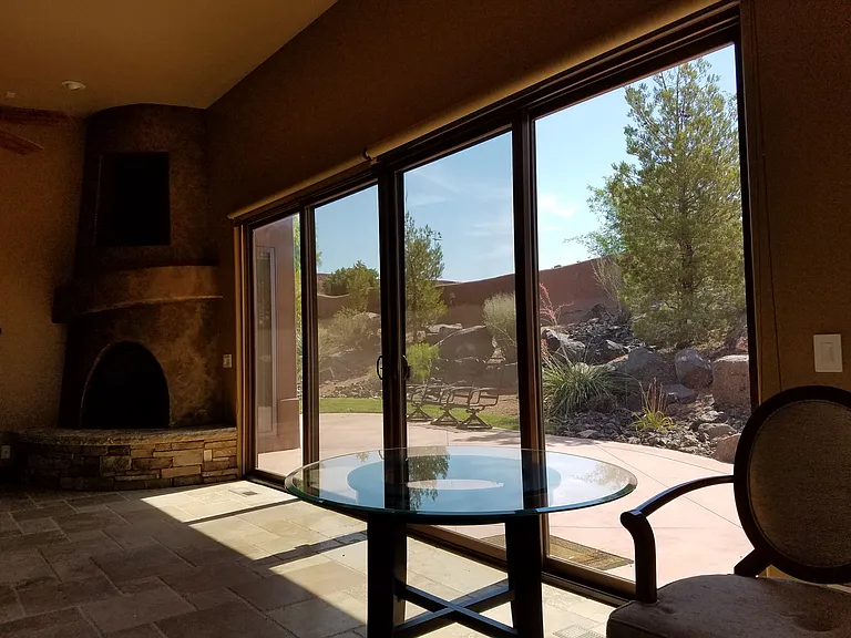 view from living room thru the sliding glass doors to back patio