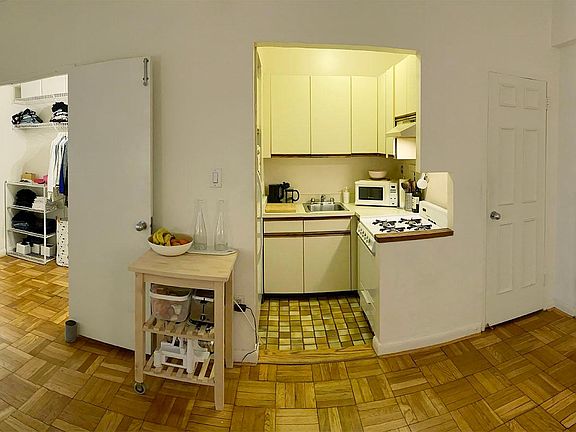 Panoramic view of walk-in closet, kitchen and entrance