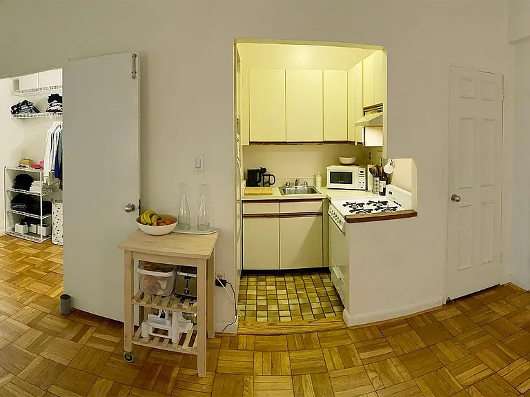 Panoramic view of walk-in closet, kitchen and entrance