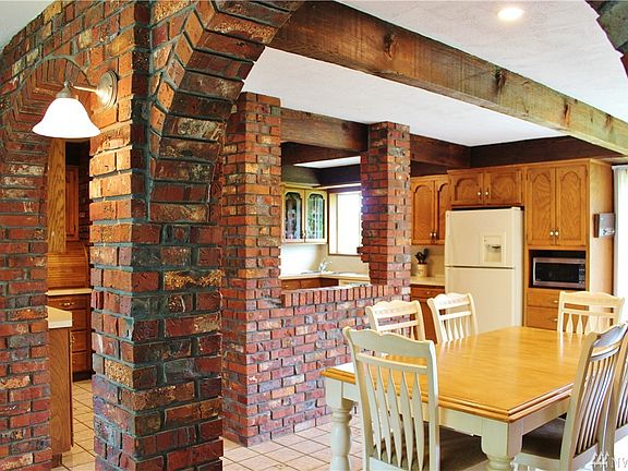 Large kitchen with solid wood cabinetry, entertaining space and evening natural light