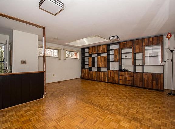 Large great rm has a skylight & built-in cabinetry