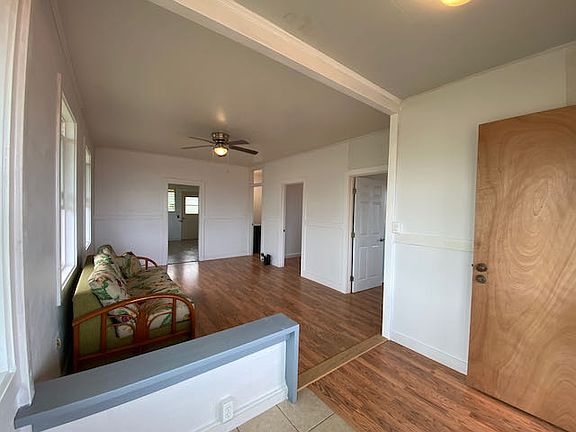 View from the front entrance of living room and connecting bedroom/bathroom doors