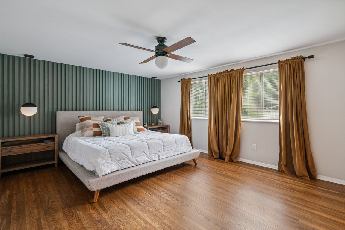 19-Primary suite with hardwood floors and custom slat wall