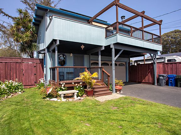 Beach house style home (Living, Kitchen, Primary bedroom, Primary bathroom on second floor). Established gardens on watering system with gardening service included.