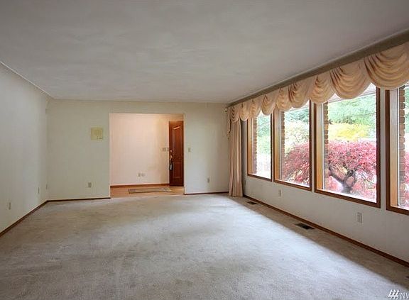 The beautiful wood wrapped windows and coved ceilings are timeless and provide a touch of class.