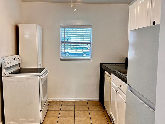 Kitchen has dishwasher, refrigerator and new flat-top stove/oven.