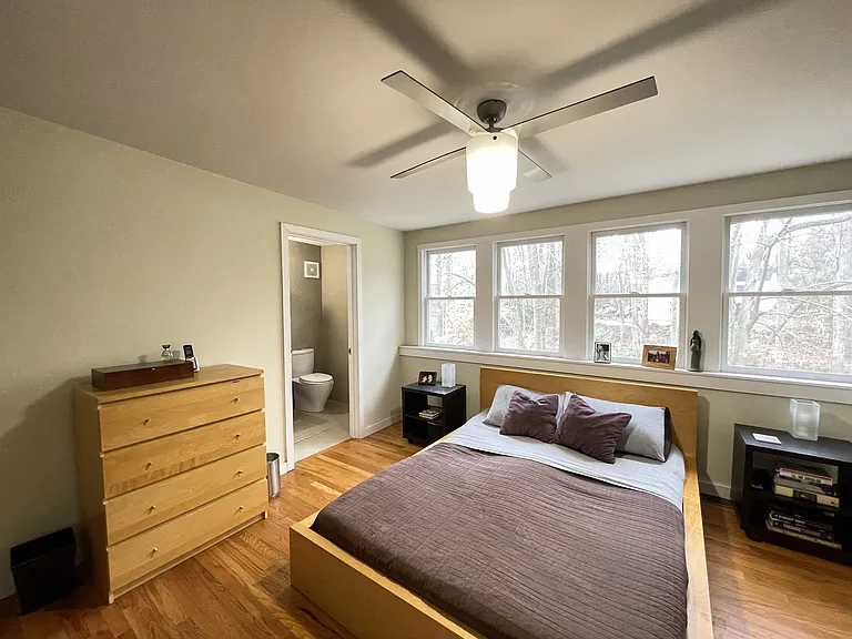 Primary Bedroom, light-filled and surrounded by forest canopy