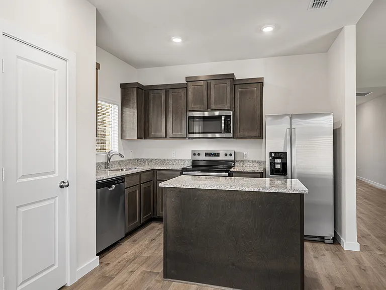 The kitchens has stainless-steel appliances and beautiful wood cabinetry.