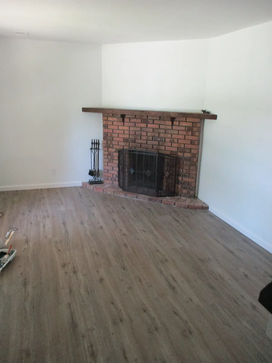 Living room with wood burning fireplace - 414 N County Rd