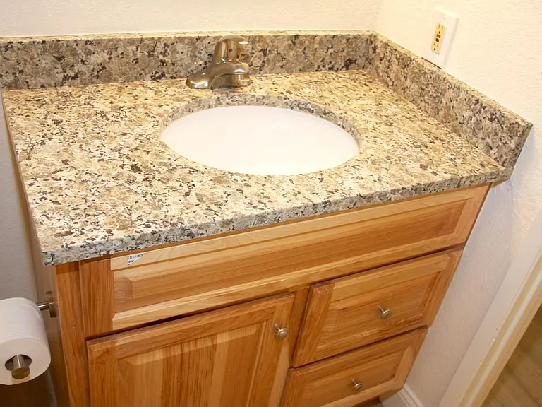 Bathroom updated in 2018, with new hickory vanity, new granite countertop, new satin nickel faucet.