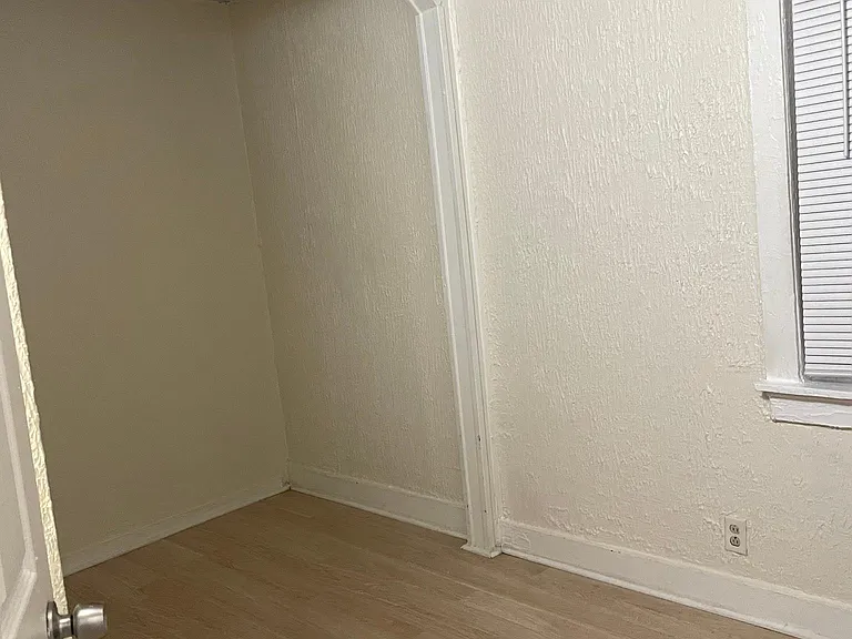 2nd bedroom with windows to side porch and small closet