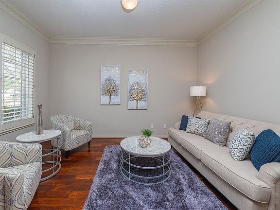The formal living room which could be used as a study is on the left as you enter the front door; featuring wood floors, crown molding and plantation shutters.