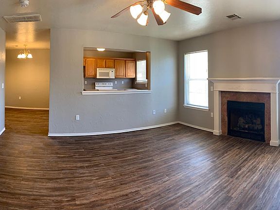 Panoramic view of the living room looking into the dining room and kitchen