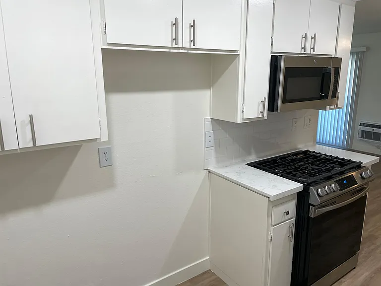 Flat level apartment kitchen with stainless steel appliances.
--
*Floor plans are digital renderings. All dimensions are approximate. Actual product and specifications may vary in dimension or detail. Not all features are available in every apartment. Pri