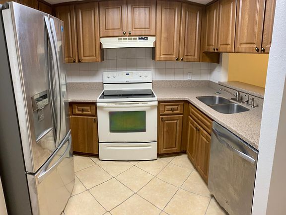 The functional kitchen boasts modern cabinets, new countertops, a garbage disposal, as well as updated appliances.